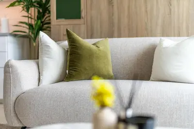 a white couch with pillows on it in a living room at Stylish Living at 8 Boulevard Walk, Downtown in Dubai