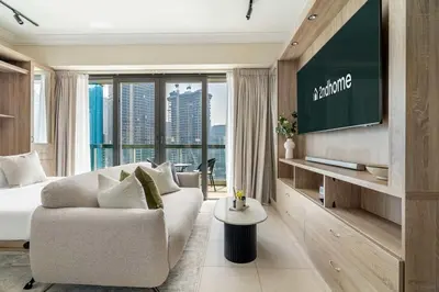 a hotel room with a couch and a tv at Stylish Living at 8 Boulevard Walk, Downtown in Dubai