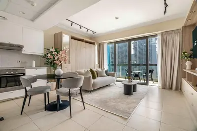 a kitchen and living room with a couch and a table at Stylish Living at 8 Boulevard Walk, Downtown in Dubai