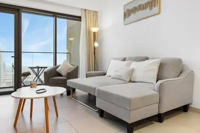a living room with a couch and a table at Downtown Comfort Spacious 1BR in Burj Royale in Dubai