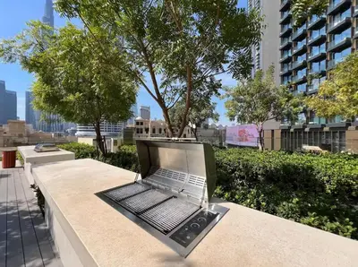 a laptop computer sitting on a bench in a city at 1BR in Emaar Burj Royale - 1min walk to Fountain&Dubai Mall, Burj view Pool & gym in Dubai