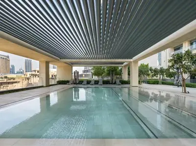 a swimming pool on the roof of a building at 1BR in Emaar Burj Royale - 1min walk to Fountain&Dubai Mall, Burj view Pool & gym in Dubai