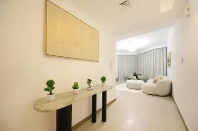 a living room with a table and a couch at Spacious 2BR in Missoni - Canal Views - Near Metro in Dubai