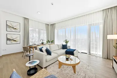 a living room with a couch and a table at New 3BD in Grove Creek Beach with Stunning View in Dubai