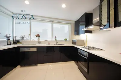 a kitchen with a sink and a counter top at Water Edge 2BR - Panoramic 360 Canal View in Dubai
