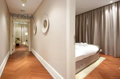 a hotel room with a bed and a hallway at Water Edge 2BR - Panoramic 360 Canal View in Dubai