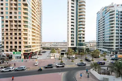a city with tall buildings and a street with cars at 1BR w Marina Views & Balcony in Dubai