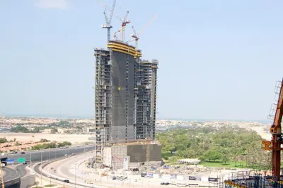 a tall building under construction with cranes at Luxury Studio in Aykon Tower - Pool & Gym Access in Dubai