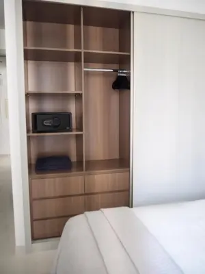 a bedroom with a closet with a bed and a book shelf at OceanView 1bed apartment with Private Beach in Dubai