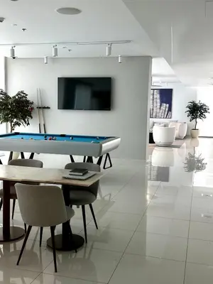 a living room with a pool table and chairs at OceanView 1bed apartment with Private Beach in Dubai