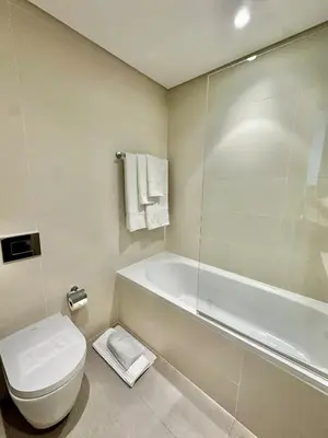 a bathroom with a tub and a toilet and a shower at OceanView 1bed apartment with Private Beach in Dubai
