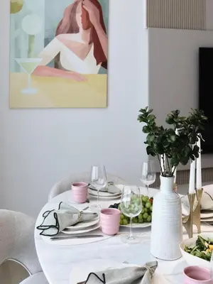a dining room table with a white table cloth and a white vase at JVC - Designer 2 BHK apartment - Pool&Gym - by MKB LIVING in Dubai