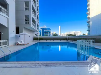 a swimming pool in the middle of a building at Relaxing ST Getaway l Balcony, Pool & Gym Access in Dubai