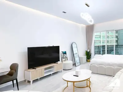 a white living room with a large flat screen tv at Relaxing ST Getaway l Balcony, Pool & Gym Access in Dubai