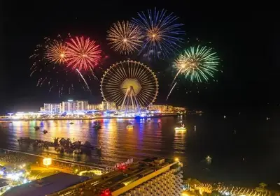 a ferris wheel with fireworks over the water at night at Jumeirah Beachfront with Ain View and Sea View 2BR in Dubai