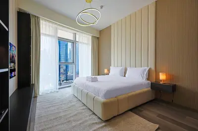 a bedroom with a large bed and a large window at Modern Sophistication with Stunning City Views in Dubai