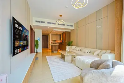 a living room with a couch and a table at Modern Sophistication with Stunning City Views in Dubai