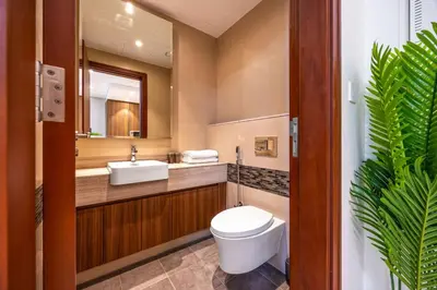 a bathroom with a toilet and a sink and a mirror at Modern Sophistication with Stunning City Views in Dubai