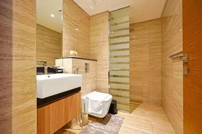a bathroom with a white sink and a shower at Luxury Studio Retreat Canal View and City Life in Dubai