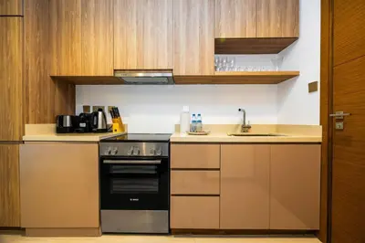 a kitchen with a stove and a sink at Luxury Studio Retreat Canal View and City Life in Dubai
