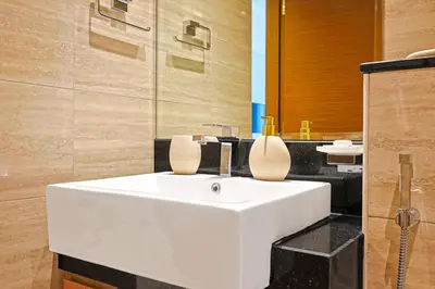 a bathroom with a white sink and a mirror at Luxury Studio Retreat Canal View and City Life in Dubai