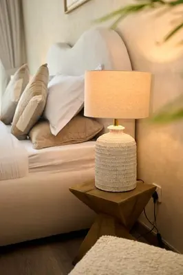 a lamp on a table next to a bed at Luxury 1BR Apt Dowtown Dubai Imperial Avenue with Burj Khalifa Views in Dubai