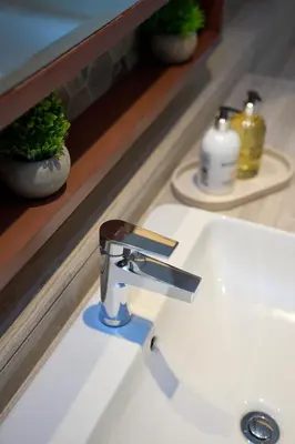 a bathroom sink with a faucet in front of a mirror at Luxury 1BR Apt Dowtown Dubai Imperial Avenue with Burj Khalifa Views in Dubai