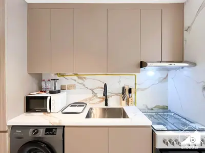 a kitchen with a sink and a microwave at Elegant Studio with Balcony & Full Amenities in Dubai