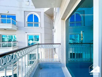 a balcony of a building with a swimming pool at Elegant Studio with Balcony & Full Amenities in Dubai