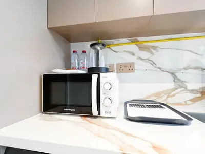 a microwave sitting on top of a counter at Elegant Studio with Balcony & Full Amenities in Dubai
