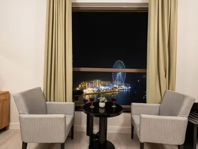 a room with two chairs and a table in front of a window at JBR Beachfront with Full Sea and Ain Dubai View in Dubai