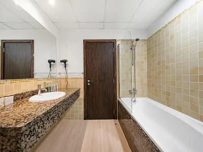 a bathroom with a tub and a sink and a bath tub at JBR Beachfront with Full Sea and Ain Dubai View in Dubai