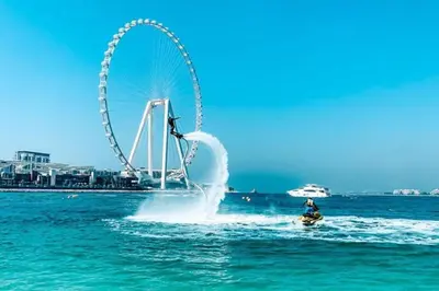 a ferris wheel in the middle of the water at JBR Dubai VIP Lux Penthouse priv Pool cinema Limo tranfer-housekeeper in Dubai