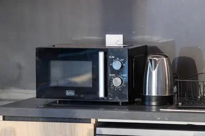 a microwave sitting on top of a counter at Mahogany 18 - 2BR 10 Guests - Walk to Dubai Mall in Dubai