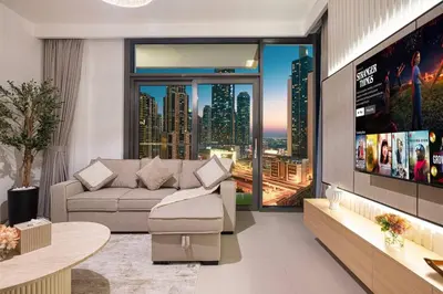 a living room with a couch and a tv at Mahogany 18 - 2BR 10 Guests - Walk to Dubai Mall in Dubai