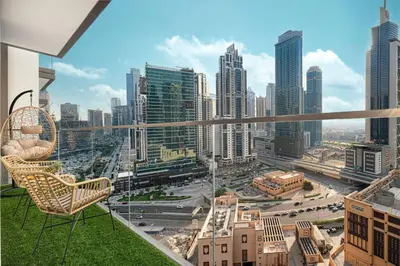 a balcony with chairs and a view of a city at Mahogany 18 - 2BR 10 Guests - Walk to Dubai Mall in Dubai