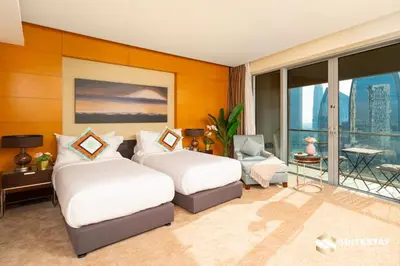 two beds in a hotel room with a balcony at Suitestay-Fahion Avenue Dubai mall in Dubai