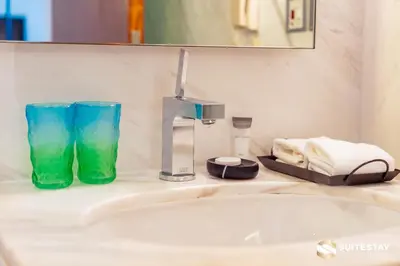 a bathroom counter with a sink and a faucet at Suitestay-Fahion Avenue Dubai mall in Dubai