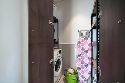 a laundry room with a washer and a washing machine at Skyline Aura 1 & 2 Bedroom Apartments I Burj Khalifa & Fountain Views I Dubai Mall Access I Parking, Gym, Wi-Fi & Infinity Pool in Dubai
