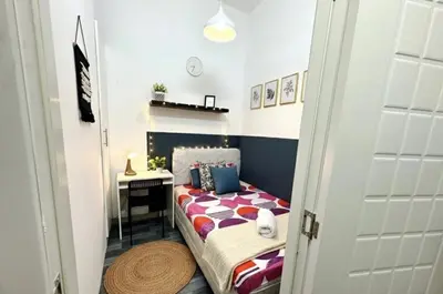 a small bedroom with a bed and a desk at Limelight Partiton Room In Tecom Barsha Heights Near ICM Metro in Dubai