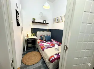 a small bedroom with a bed and a desk at Limelight Partiton Room In Tecom Barsha Heights Near ICM Metro in Dubai