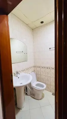 a bathroom with a toilet and a sink at Limelight Partiton Room In Tecom Barsha Heights Near ICM Metro in Dubai