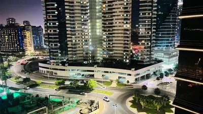 an aerial view of a city at night with buildings at Limelight Partiton Room In Tecom Barsha Heights Near ICM Metro in Dubai