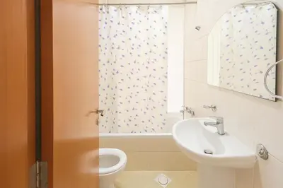 a bathroom with a sink and a toilet and a window at Private Double Room In Barsha Heights Near Metro in Dubai