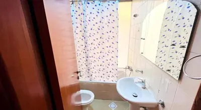 a bathroom with a sink and a toilet and a mirror at The Cozy Classic Room In Barsha Heights ICM Metro in Dubai
