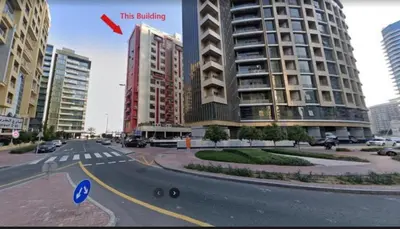 a city street with a large building in the background at Furnished Partiton Room in Tecom Barsha Heights Near ICM Metro in Dubai