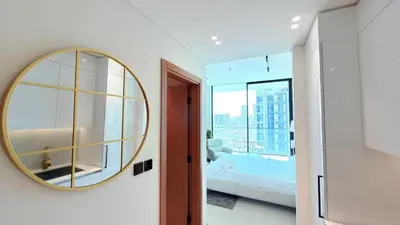 a bedroom with a large mirror and a bed at Premium Studio In Jvc Bazr in Dubai