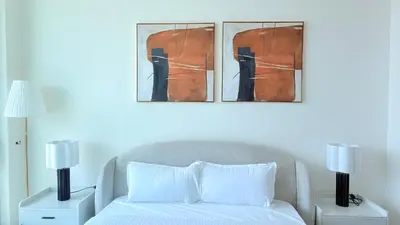 a bedroom with a bed and two pictures on the wall at Premium Studio In Jvc Bazr in Dubai