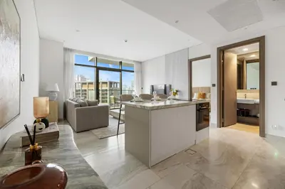a kitchen and living room with a couch and a table at 1BR with Direct Burj Khalifa View in Dubai