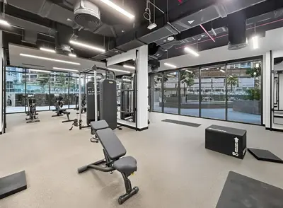 a gym with a row of treadmills and exercise equipment at 1BR with Direct Burj Khalifa View in Dubai